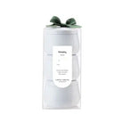 Gift set with a white box and green bow on a white background